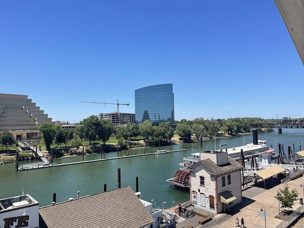 The West Sacramento waterfront: the Ziggurat and the CalSTRS tower above the Sacramento River, with the Delta King moored below