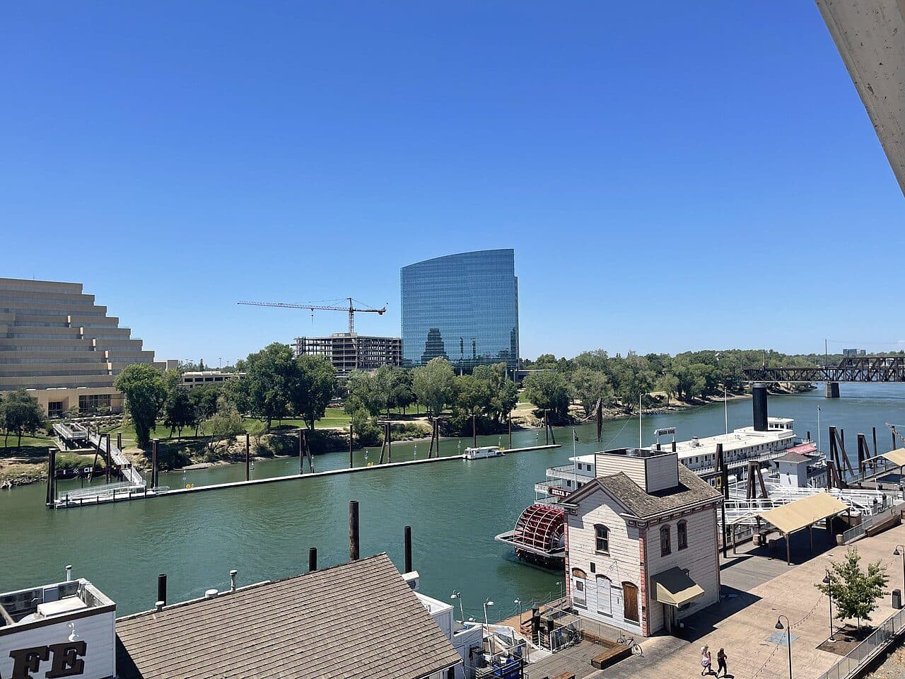 The West Sacramento waterfront: the Ziggurat and the CalSTRS tower above the Sacramento River, with the Delta King moored below